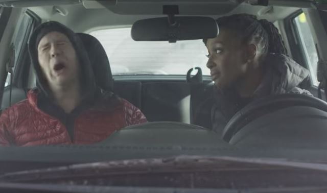 Screenshot from the show MTV Decoded. Franchesca Ramsey is looking judgementally at a tragic white man; they are passengers in the front seats of a vehicle.