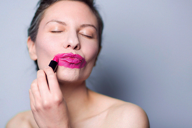 Photo: woman putting on lipstick hilariously